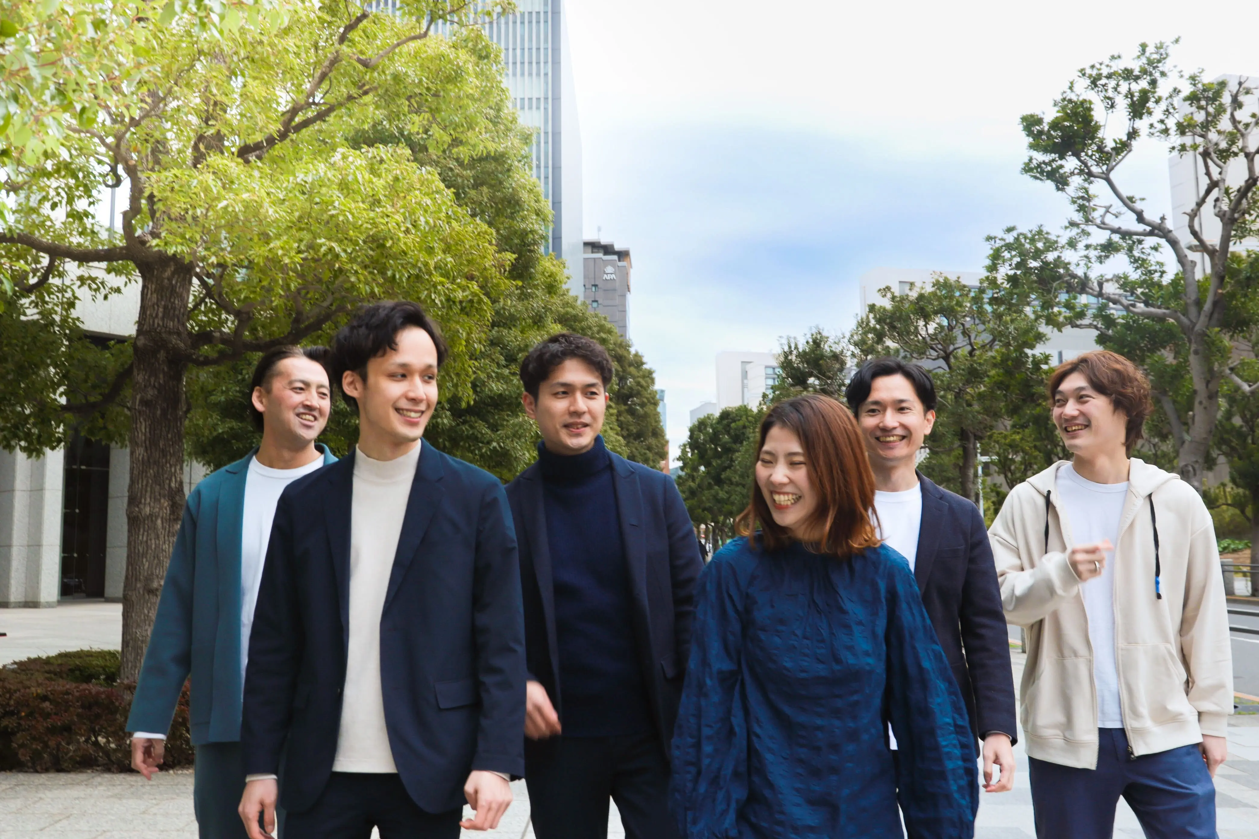 4人の社会人が会社で1つのパソコンを見ている画像